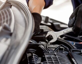 Experienced technician performing vehicle diagnostics and repair service at Downtown Auto Specialist