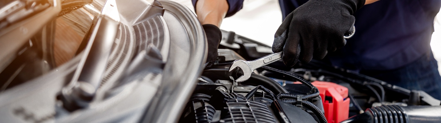 Experienced technician performing vehicle diagnostics and repair service at Downtown Auto Specialist